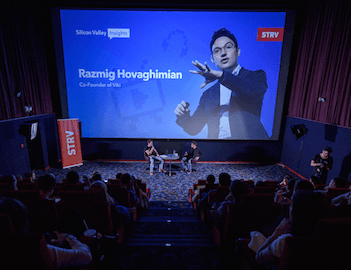 Razmig Hovaghimian, co-founder of Viki, speaks on stage during a Silicon Valley Insights event in a theater.